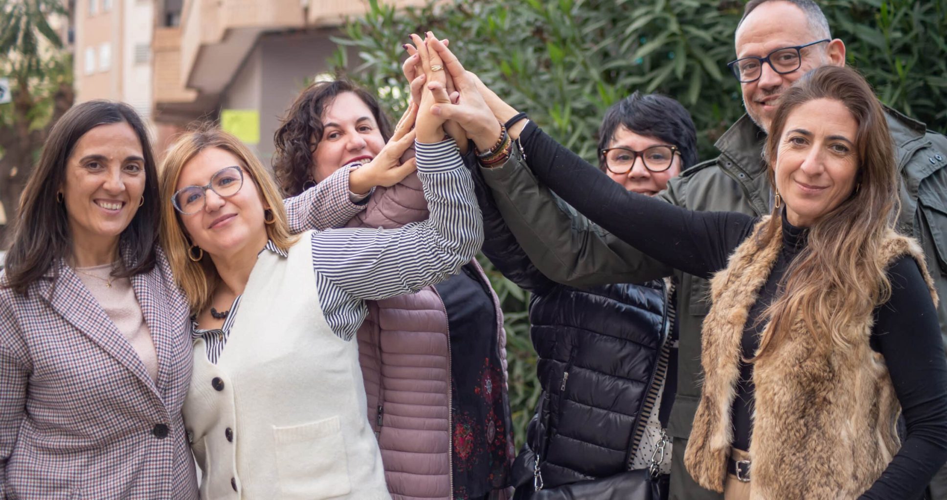 Group of people putting their hands together as a symbol of unity, teamwork, mutual support, friendship. Symbol of equality, cooperation and partnership