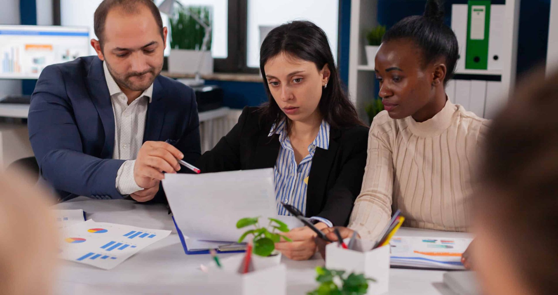 Entrepreneurs and business people conference discussing in modern meeting room. Executive explaining company's vision to employees sitting at brainstorming